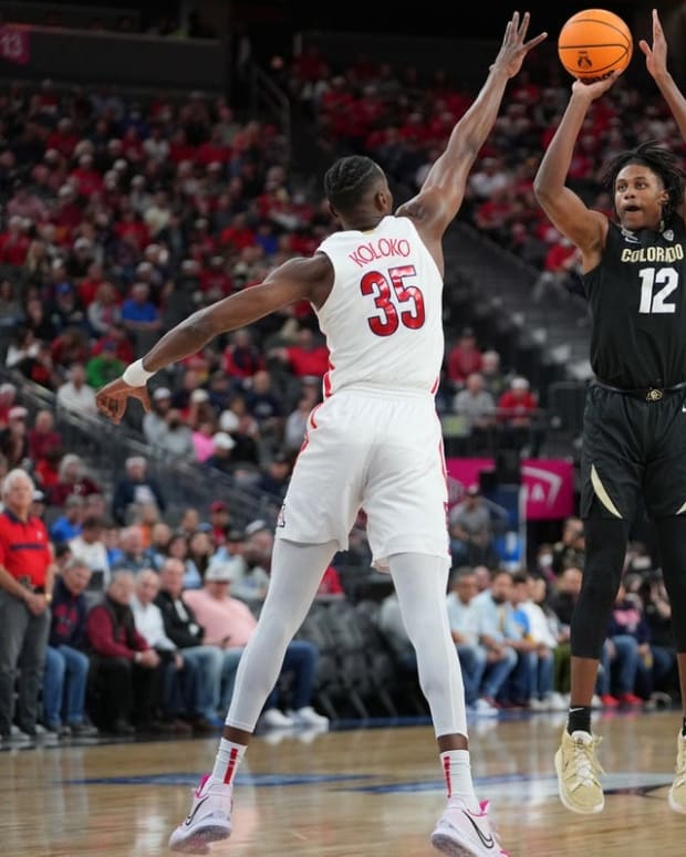 Mar 11, 2022; Las Vegas, NV, USA; Colorado Buffaloes forward Jabari Walker (12) shoots against Arizona Wildcats center Christian Koloko (35) during the first half at T-Mobile Arena. Mandatory Credit: Stephen R. Sylvanie-USA TODAY Sports
